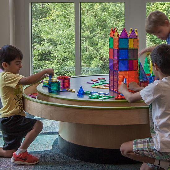 children playing with a multi-activity table